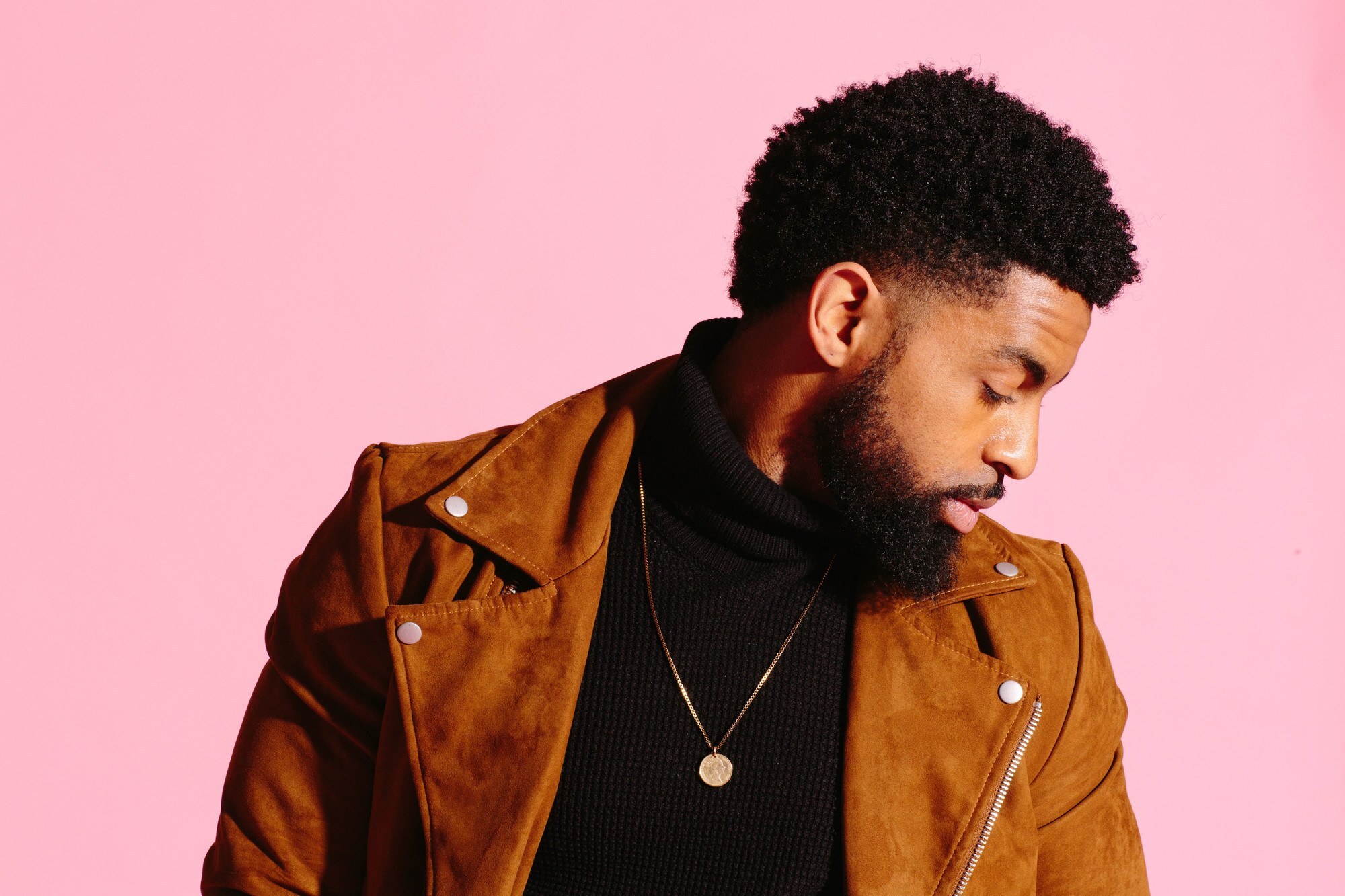 man with natural hair and slightly faded sides