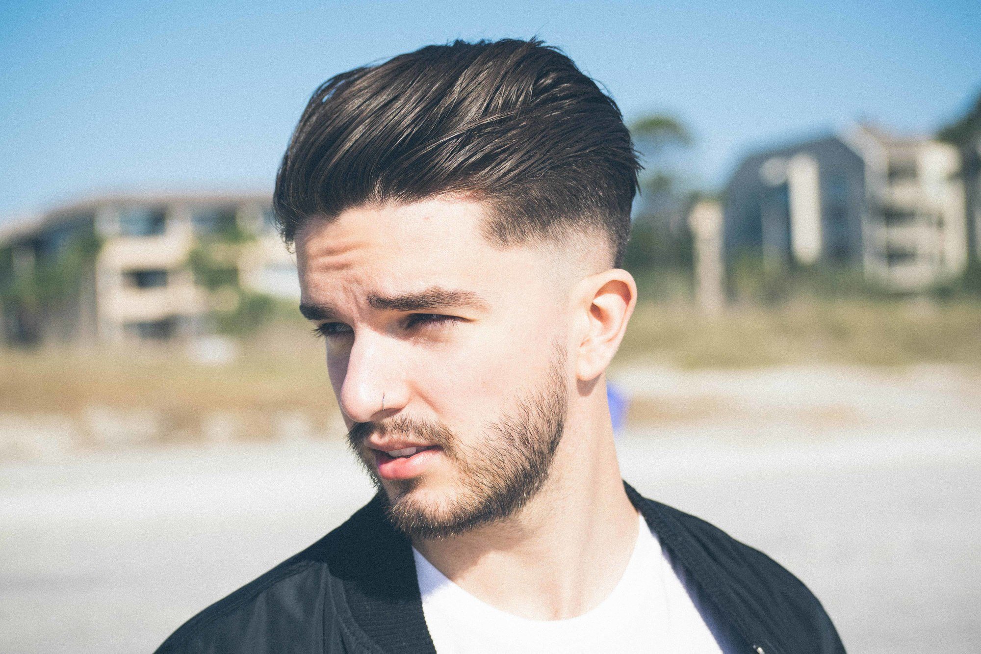 man with brushed-back hair and a fade haircut