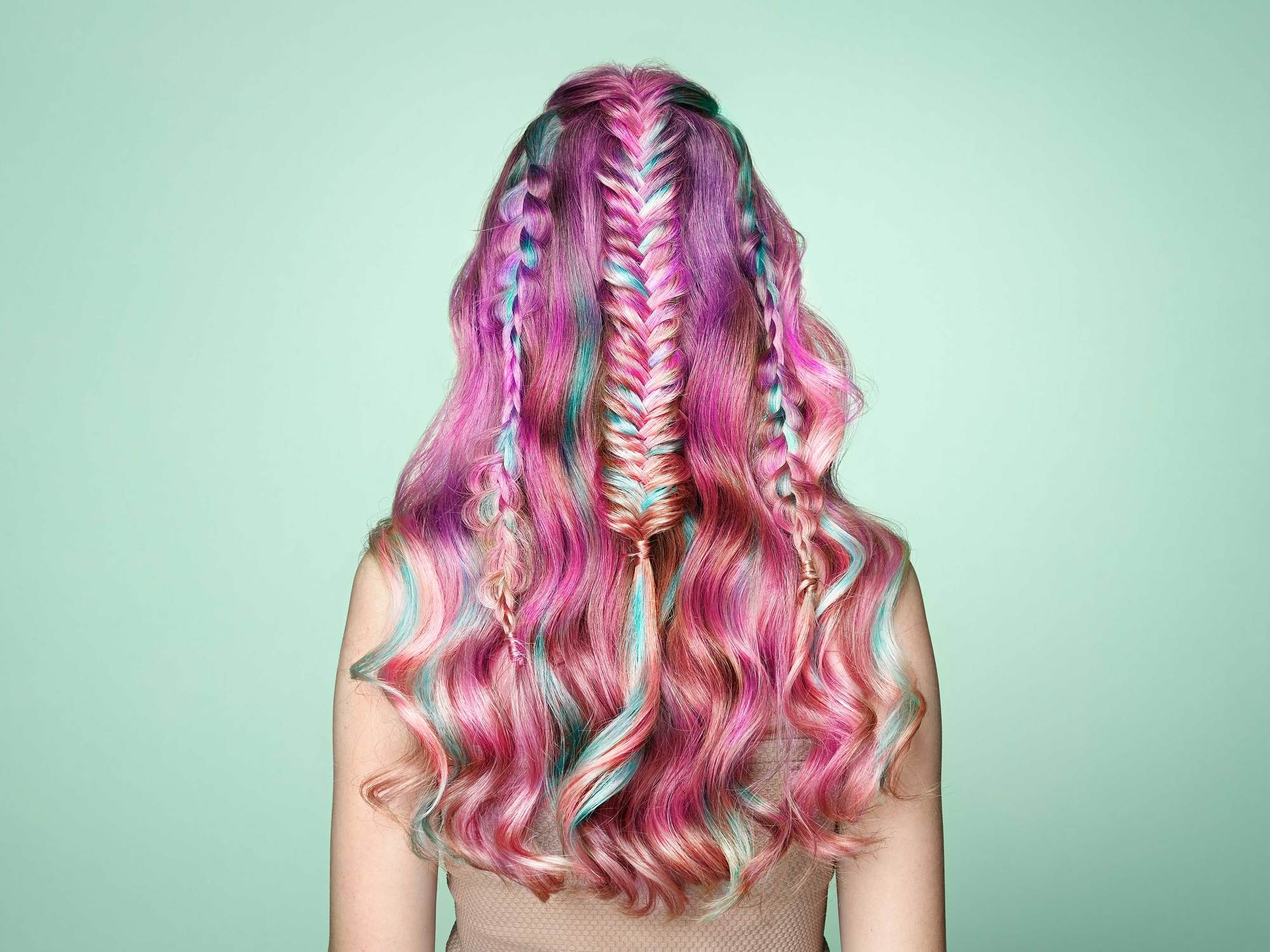 woman with rainbow pink hair curls and braids
