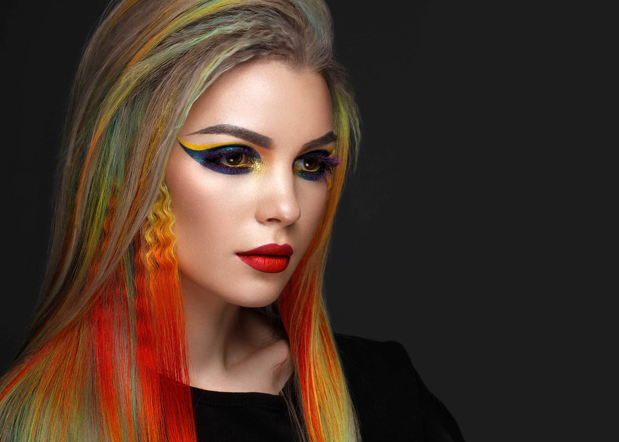 Peekaboo pride colours: woman with crimped multicoloured hair