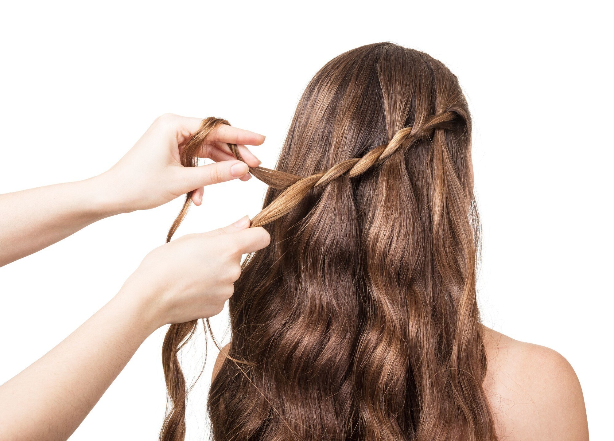 woman getting her hair braided into a waterfall braid
