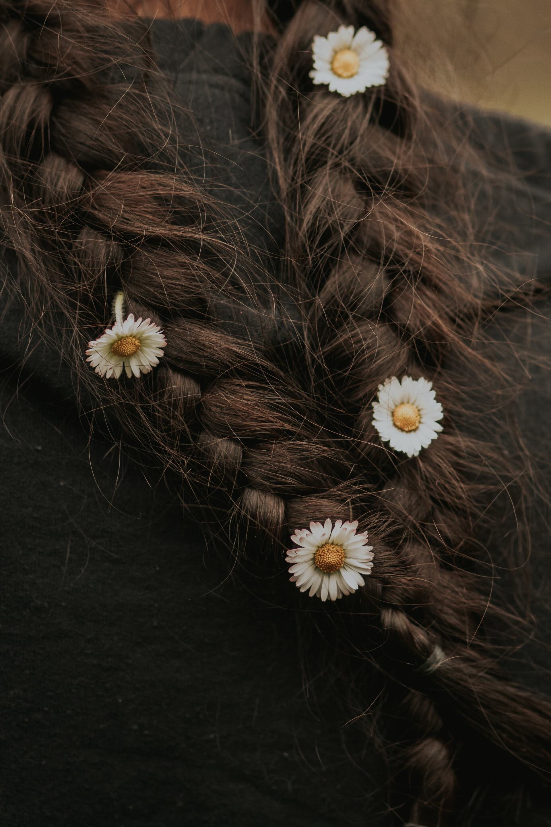 two brown braids with little flowers