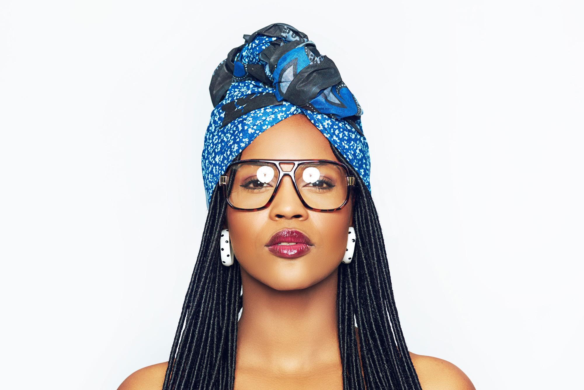 Hairstyles of great women: man with long faux dreadlocks and traditional blue headwrap