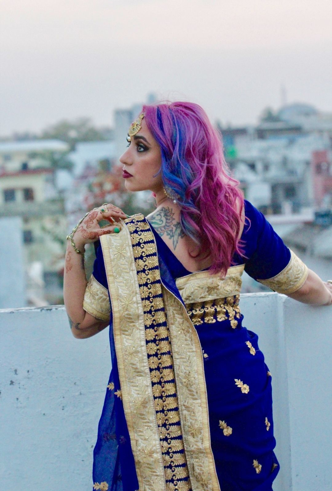 woman with bright pink wavy hair, with blue streaks