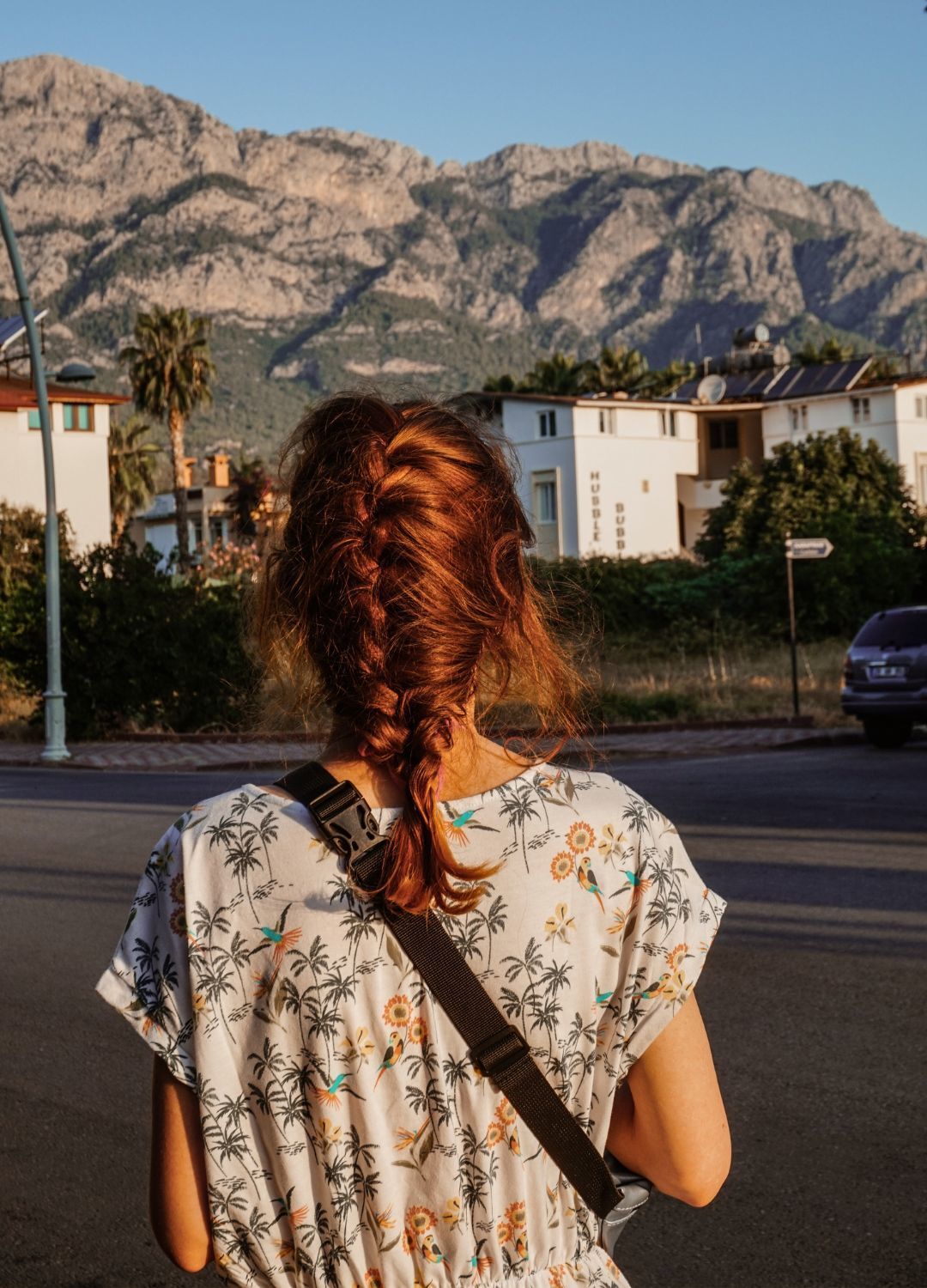 loadshedding hairstyle: girl with medium-length copper hair, braided into a french plait