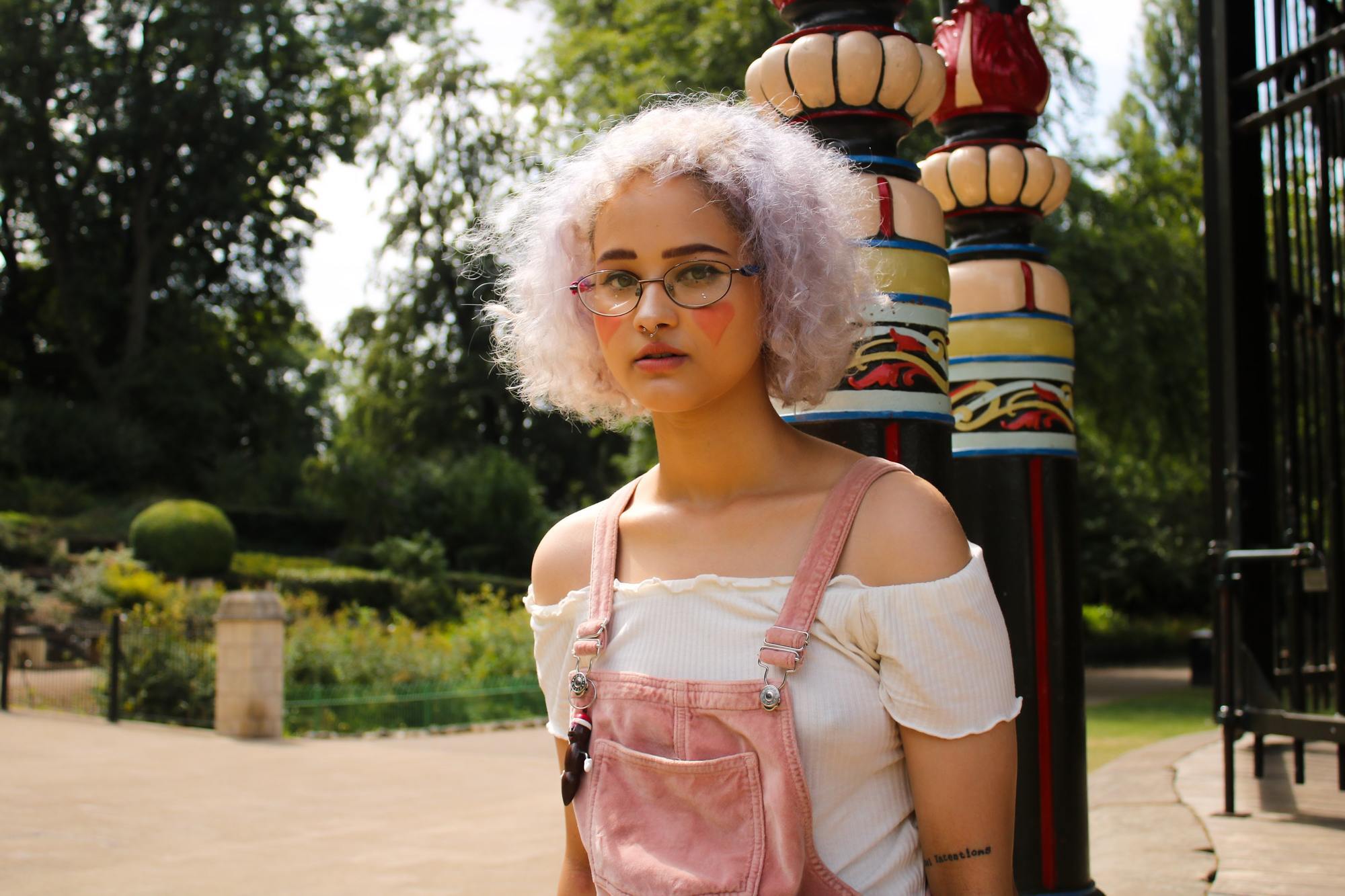 pink hair colours: woman with light pink, naturally curly hair