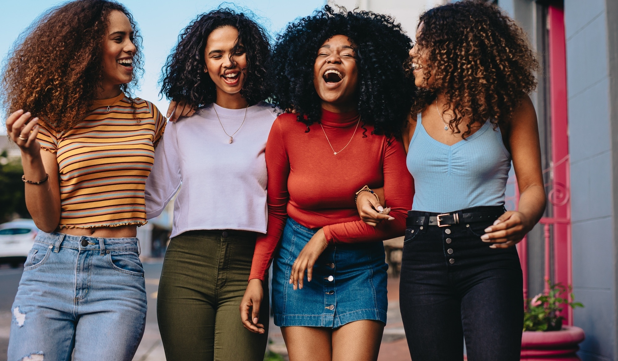 Group of curly haired women with Autumn hair colours