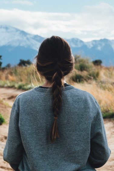woman with long loose plait ponytail hairstyle
