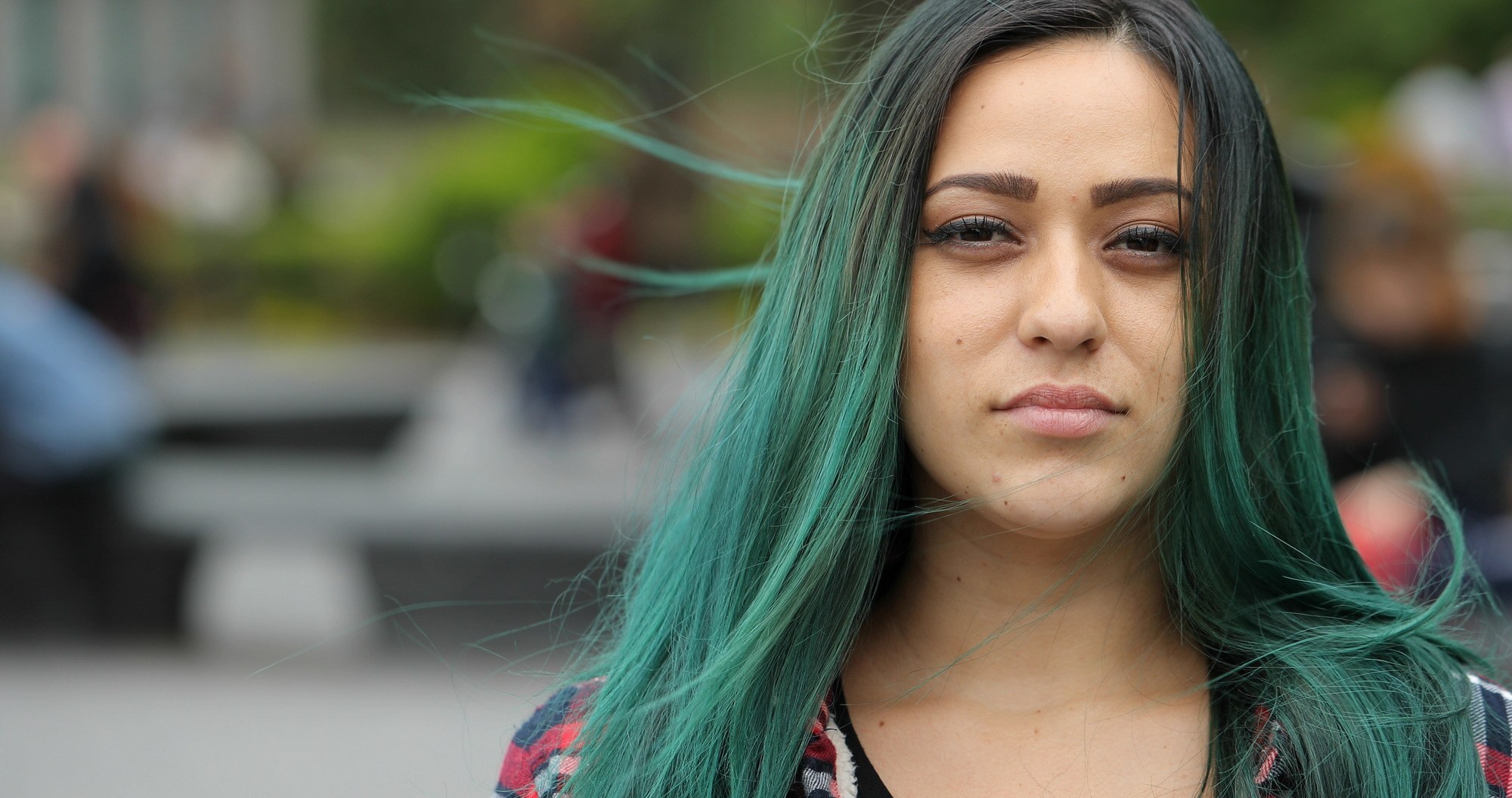 woman with green hair and dark roots