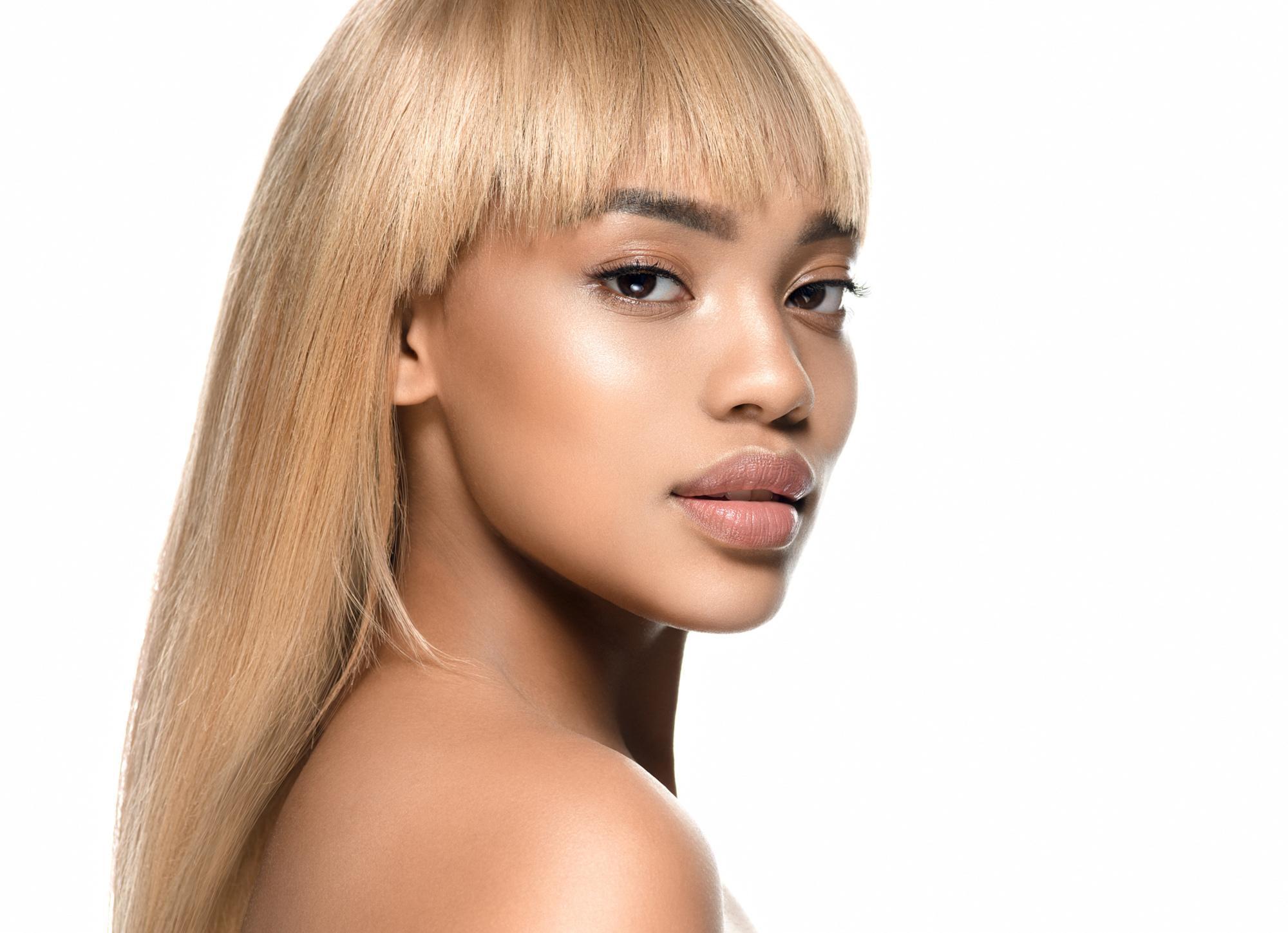 woman with long blonde hair and a fringe
