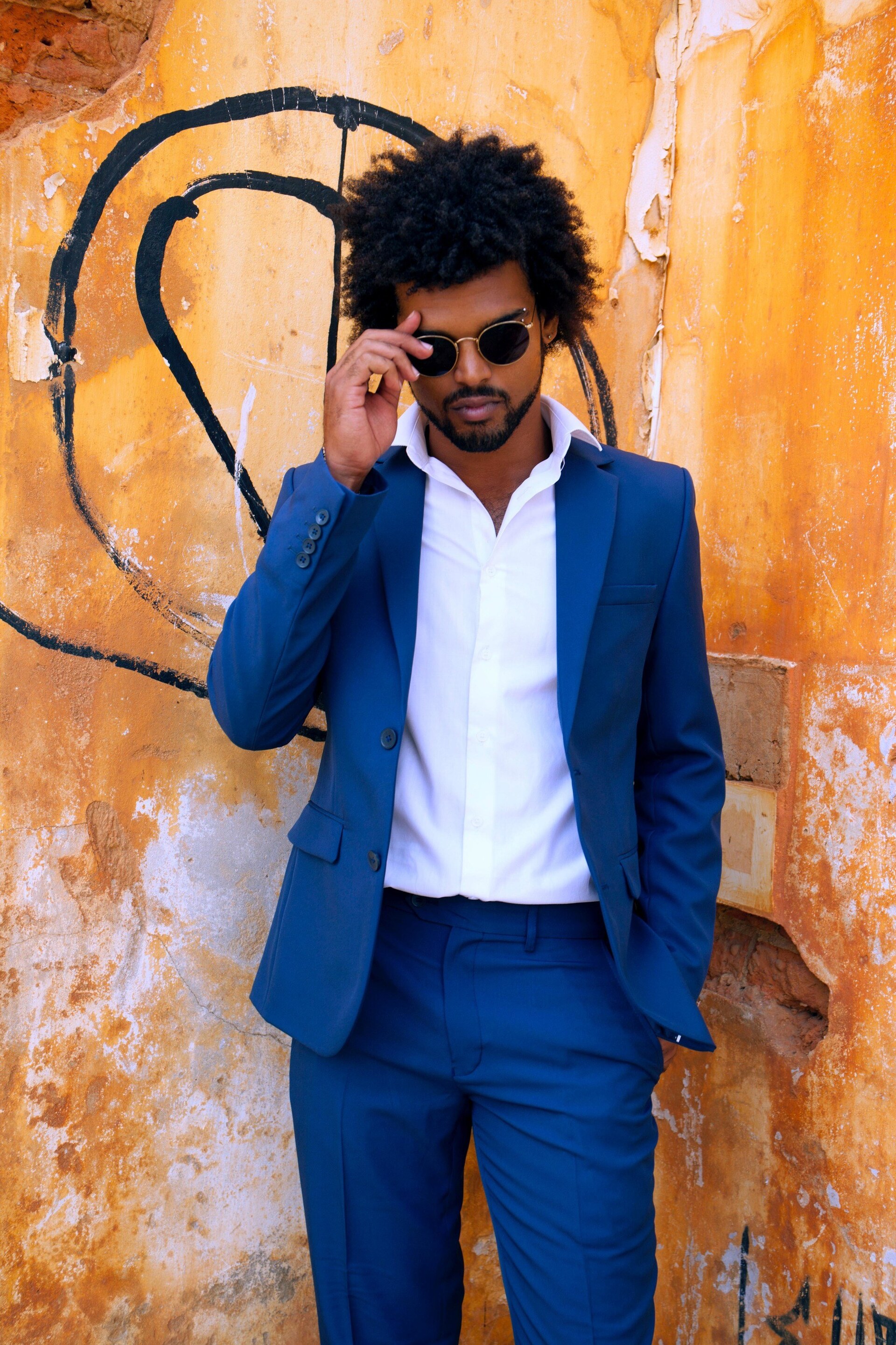 Man wearing a blue suit with medium length afro