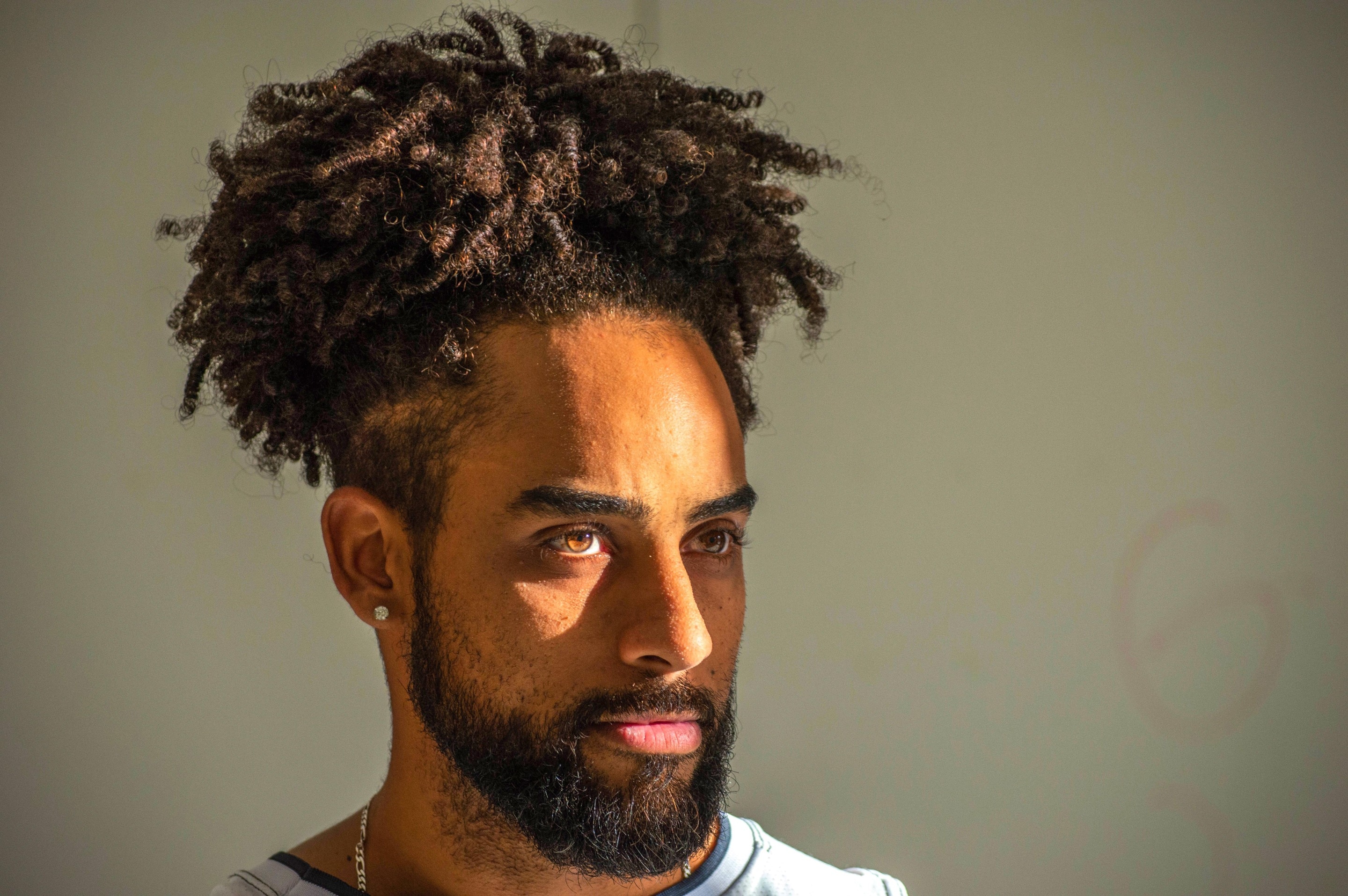 Man wearing a high curly hairstyle for men