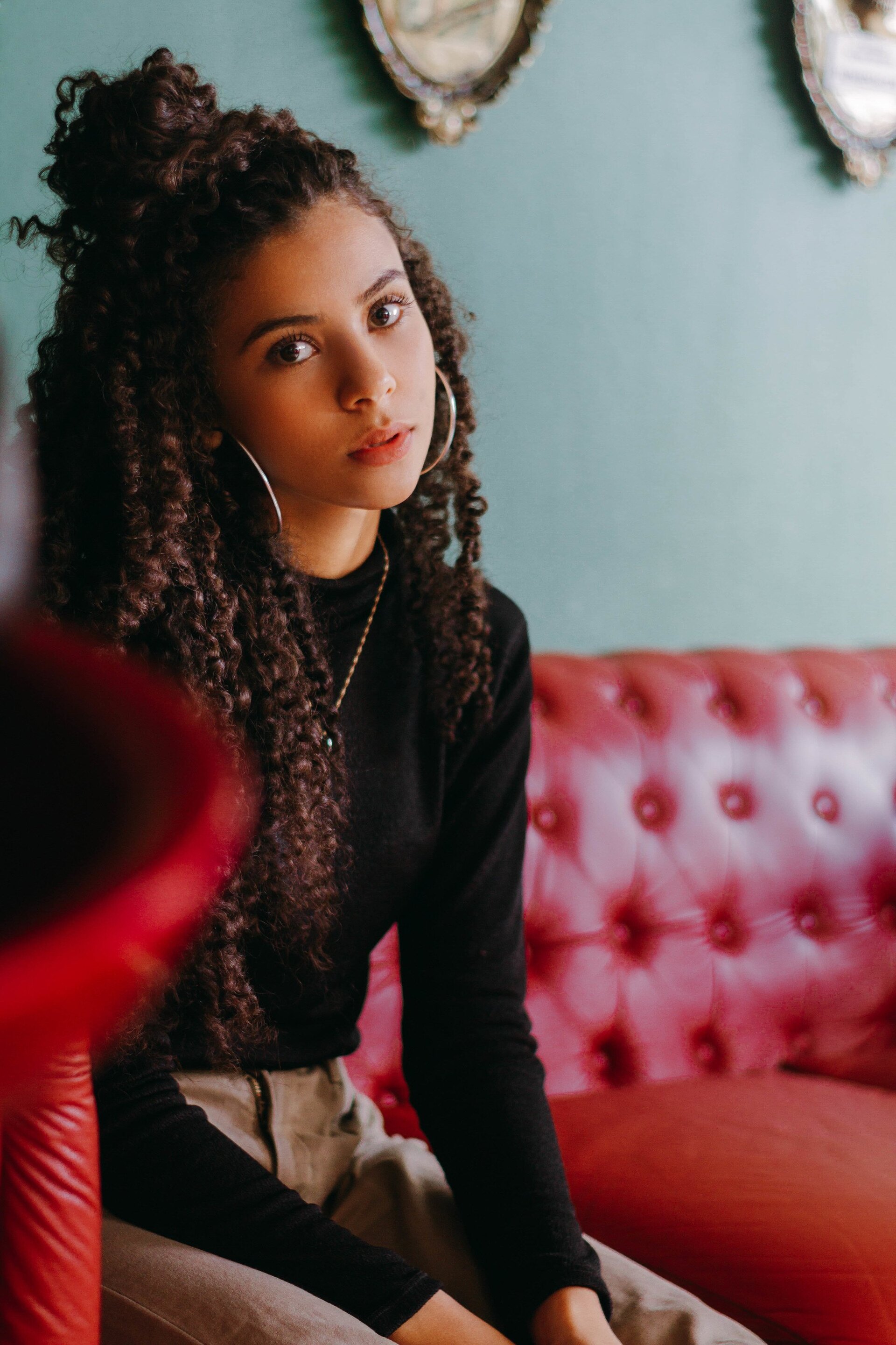 woman with curly hair half-up topknot hairstyle