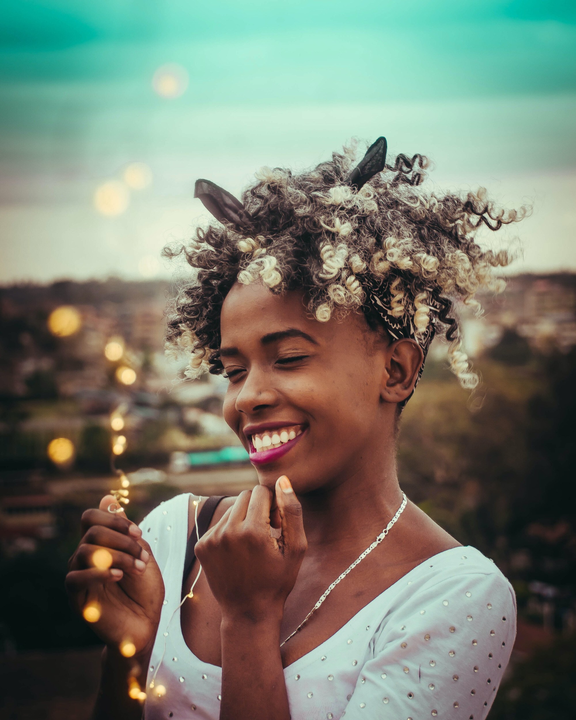 woman with curly hair and a bandana