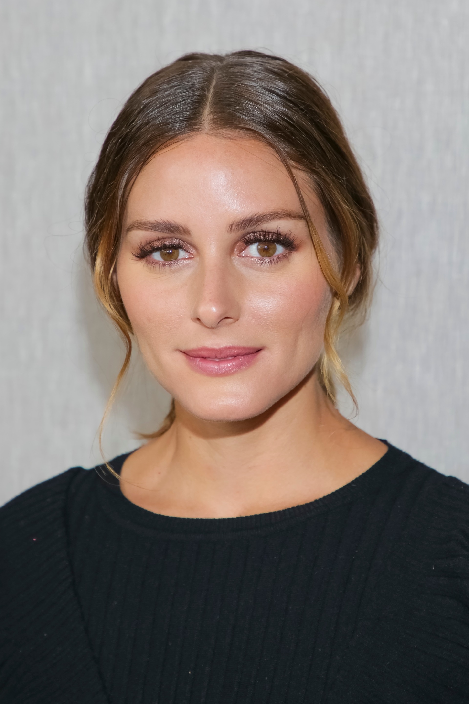 Medium hairstyles: Olivia Palermo with brown balayage hair in low undone ponytail.