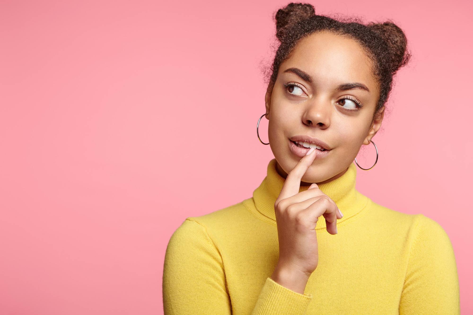 woman with natural hair space buns hairstyle