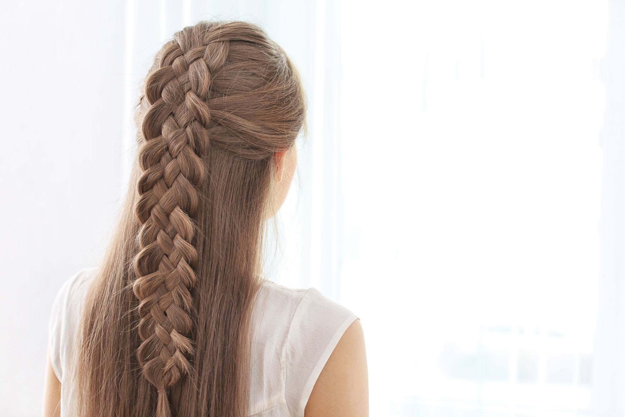 long medium brown hair with a complex centre braid