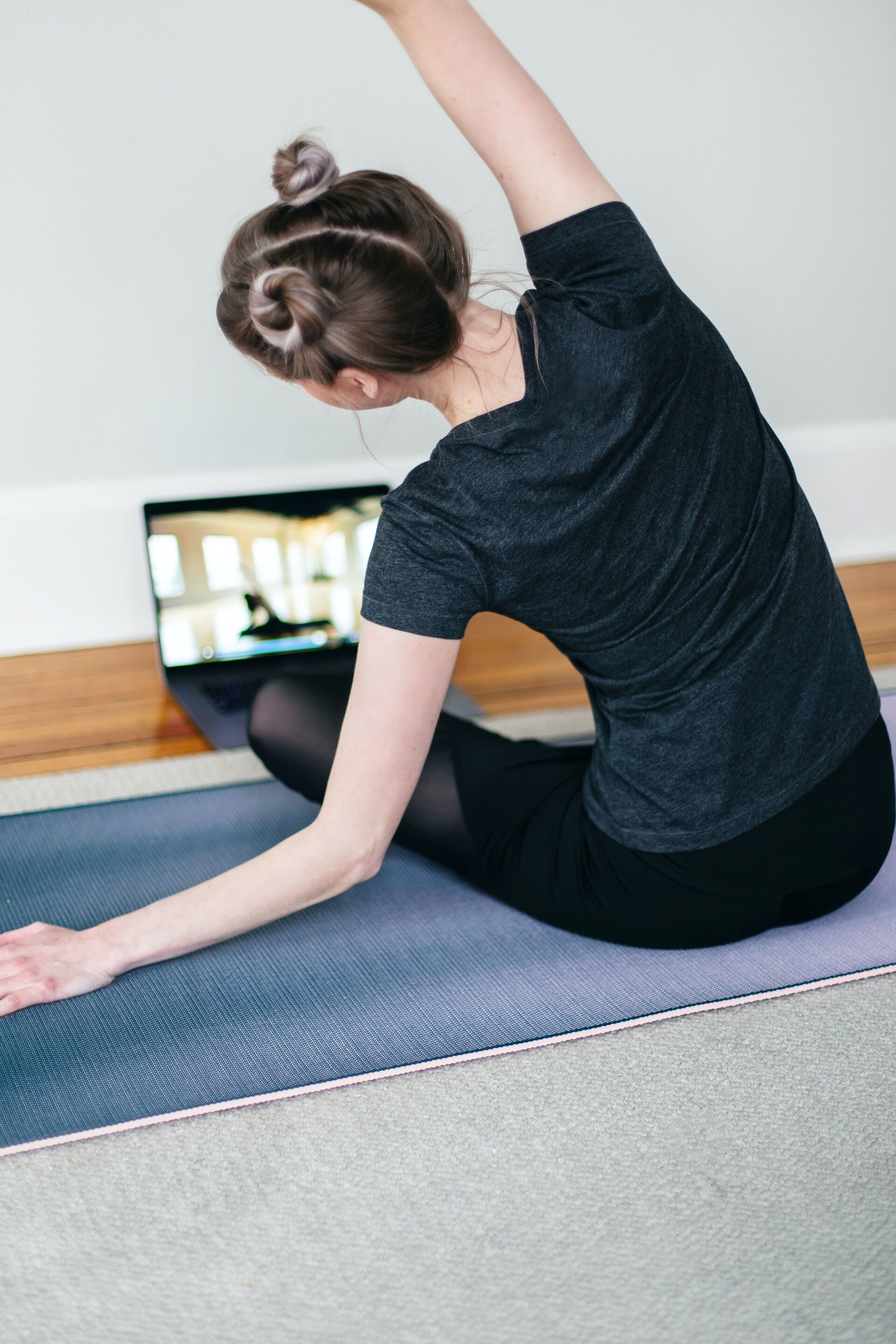 gym hairstyles for short hair: woman wearing gym clothes and a double bun space buns hairstyle