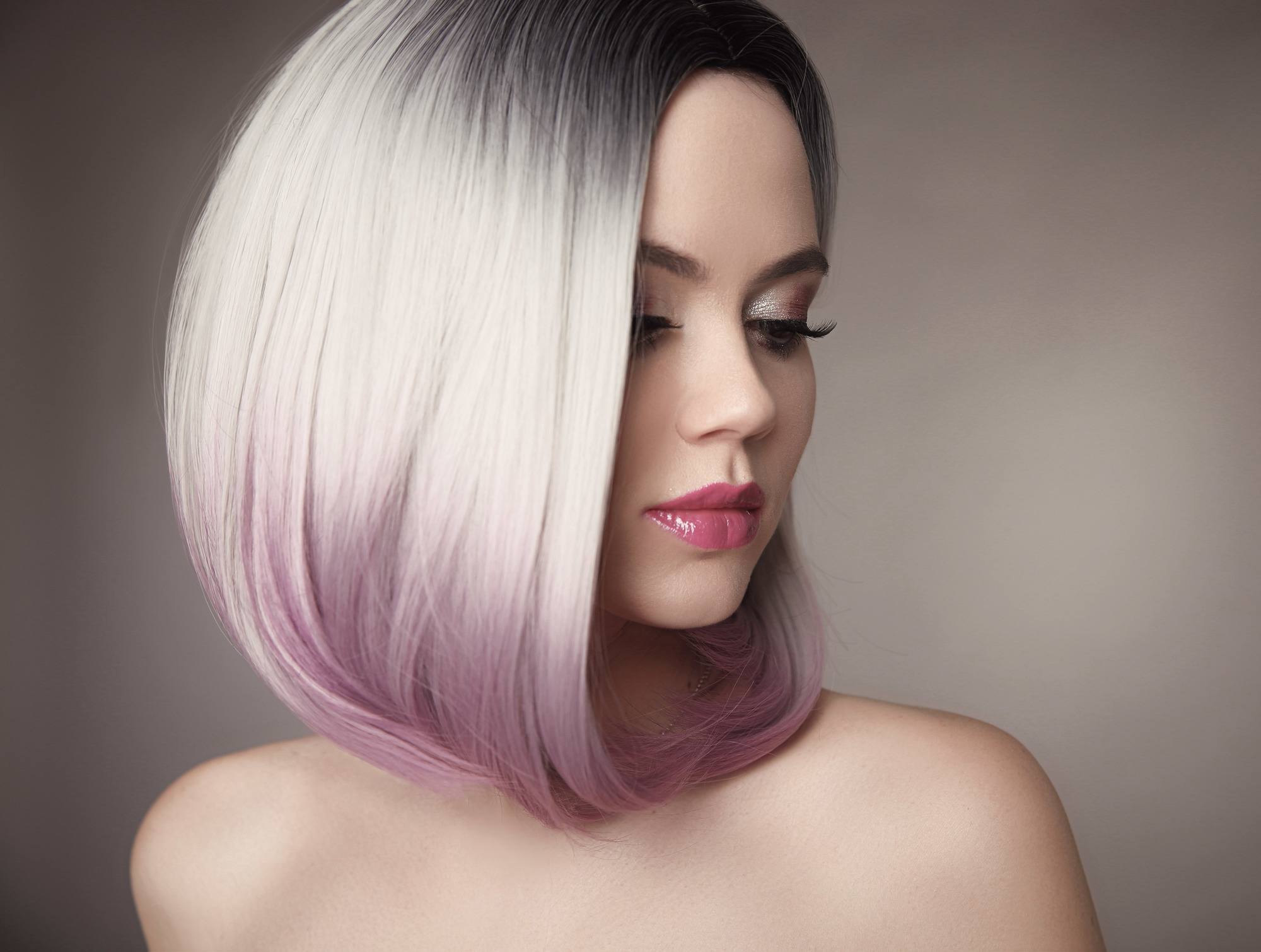 woman with white hair dark roots lilac purple ombre bob haircut