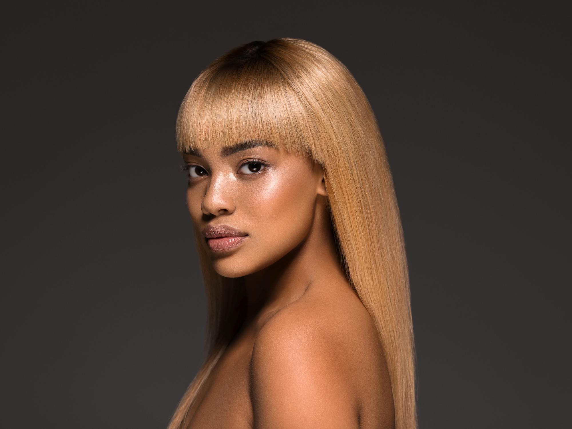 woman with long straight hair and full fringe hairstyle