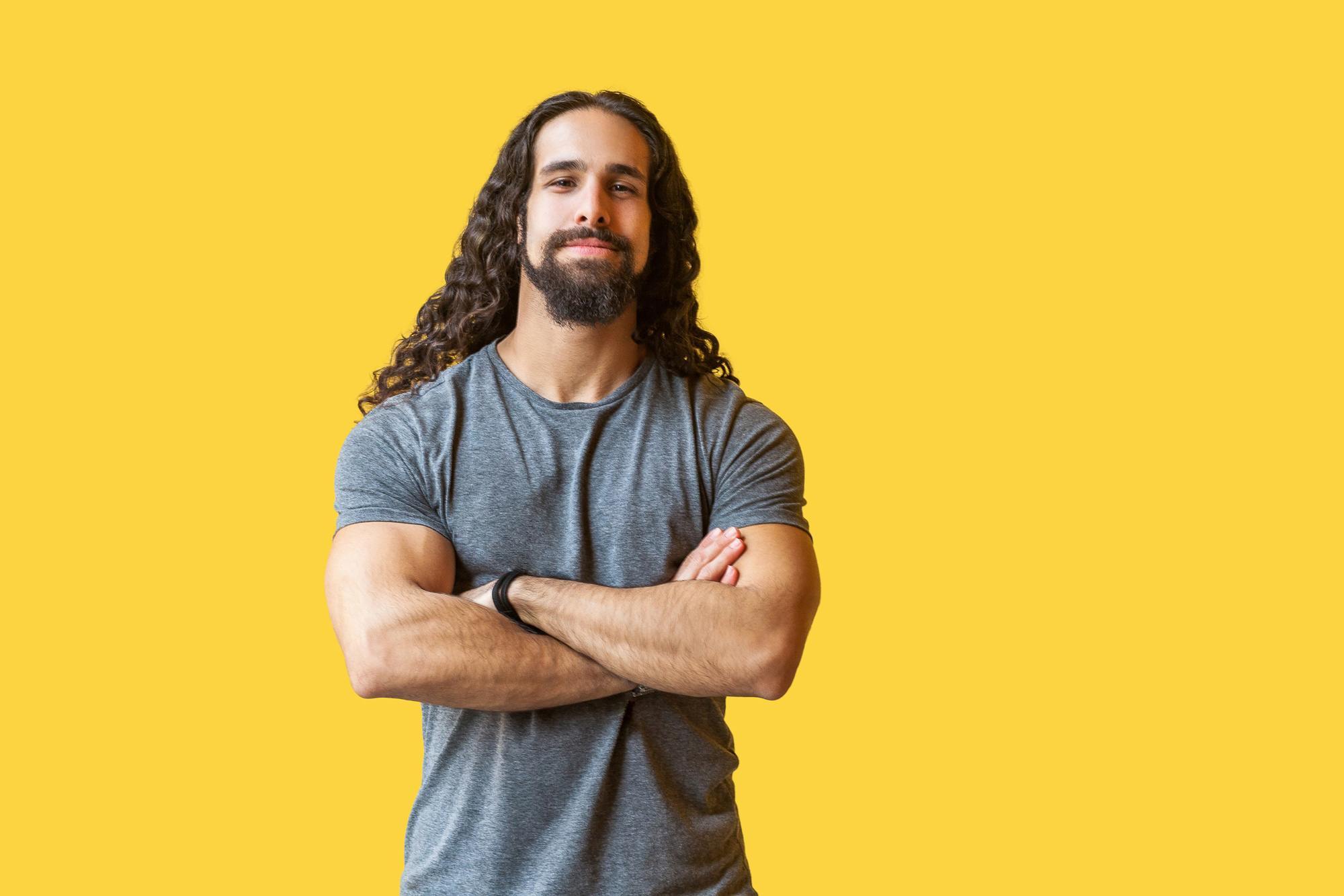 man with long wavy hair surfer waves full beard
