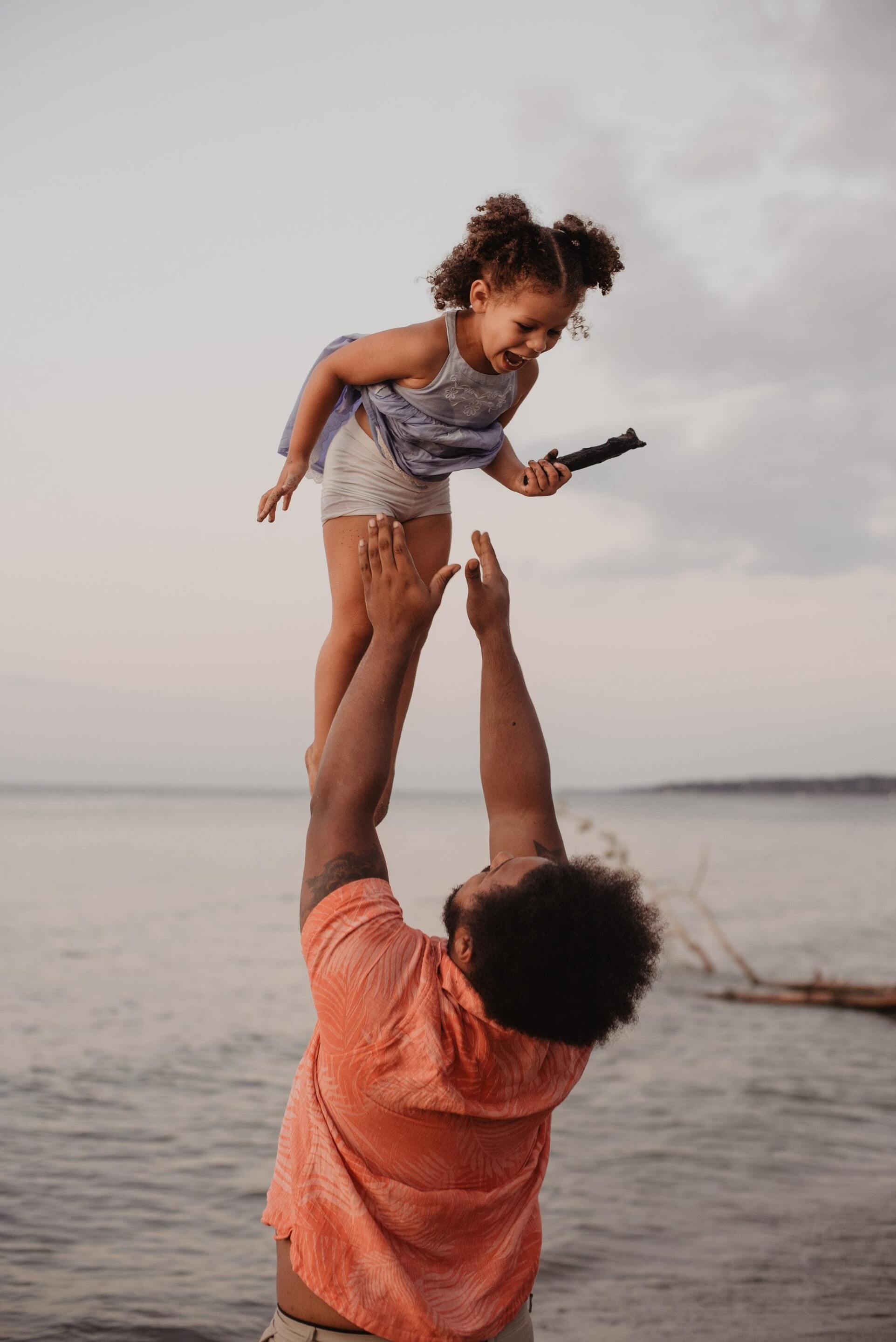Dad and daughter playing at the beach
