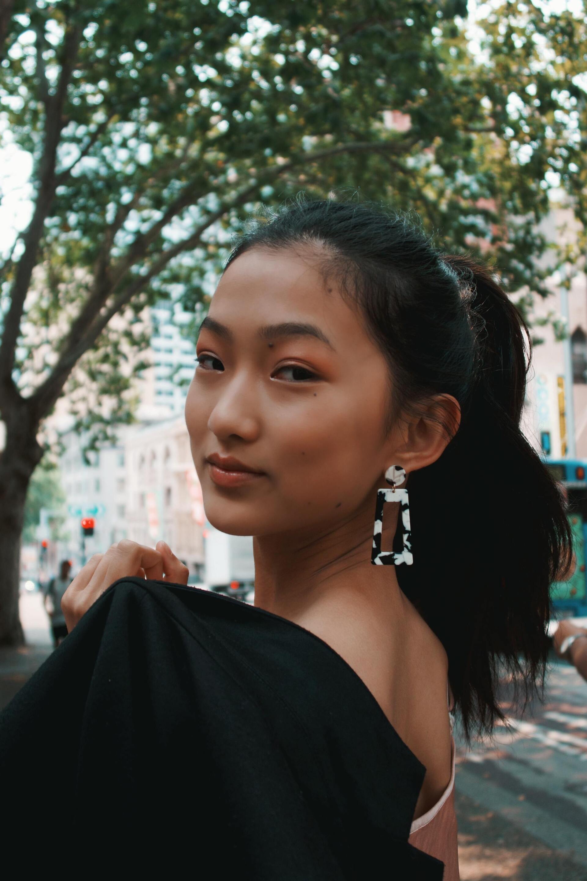 Cancer zodiac: woman with dark wavy hair tied up into a high ponytail