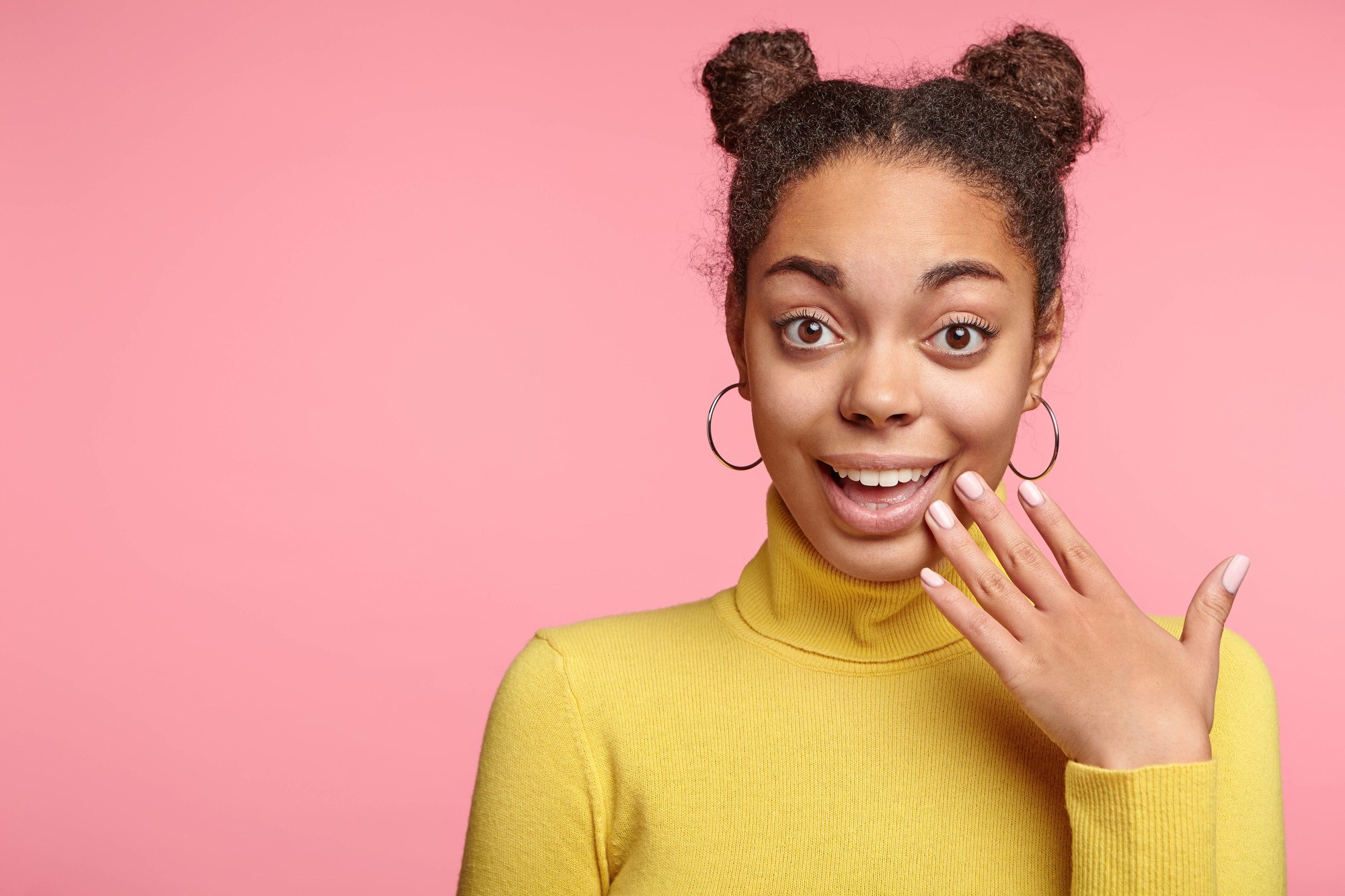 gemini hairstyles: Woman with brown hair and space buns hairstyle
