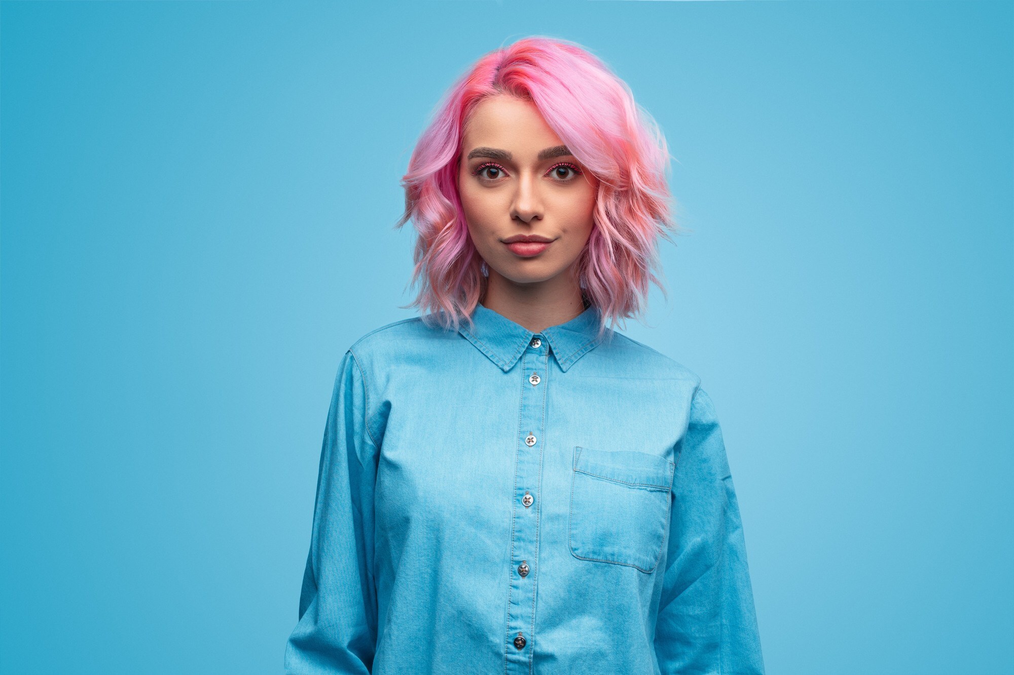 woman with a long bob hairstyle dyed bubblegum pink