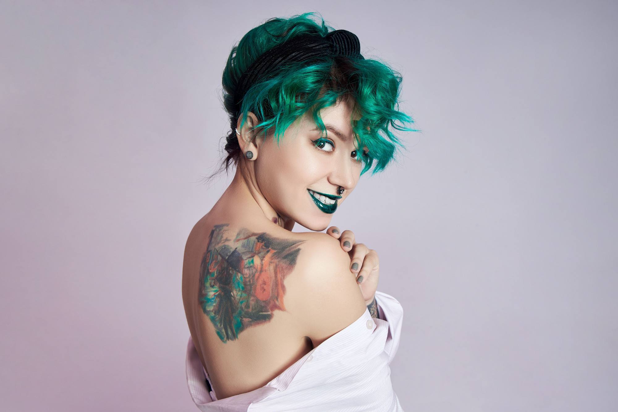 birthstone-inspired hair colour: woman with short green hair