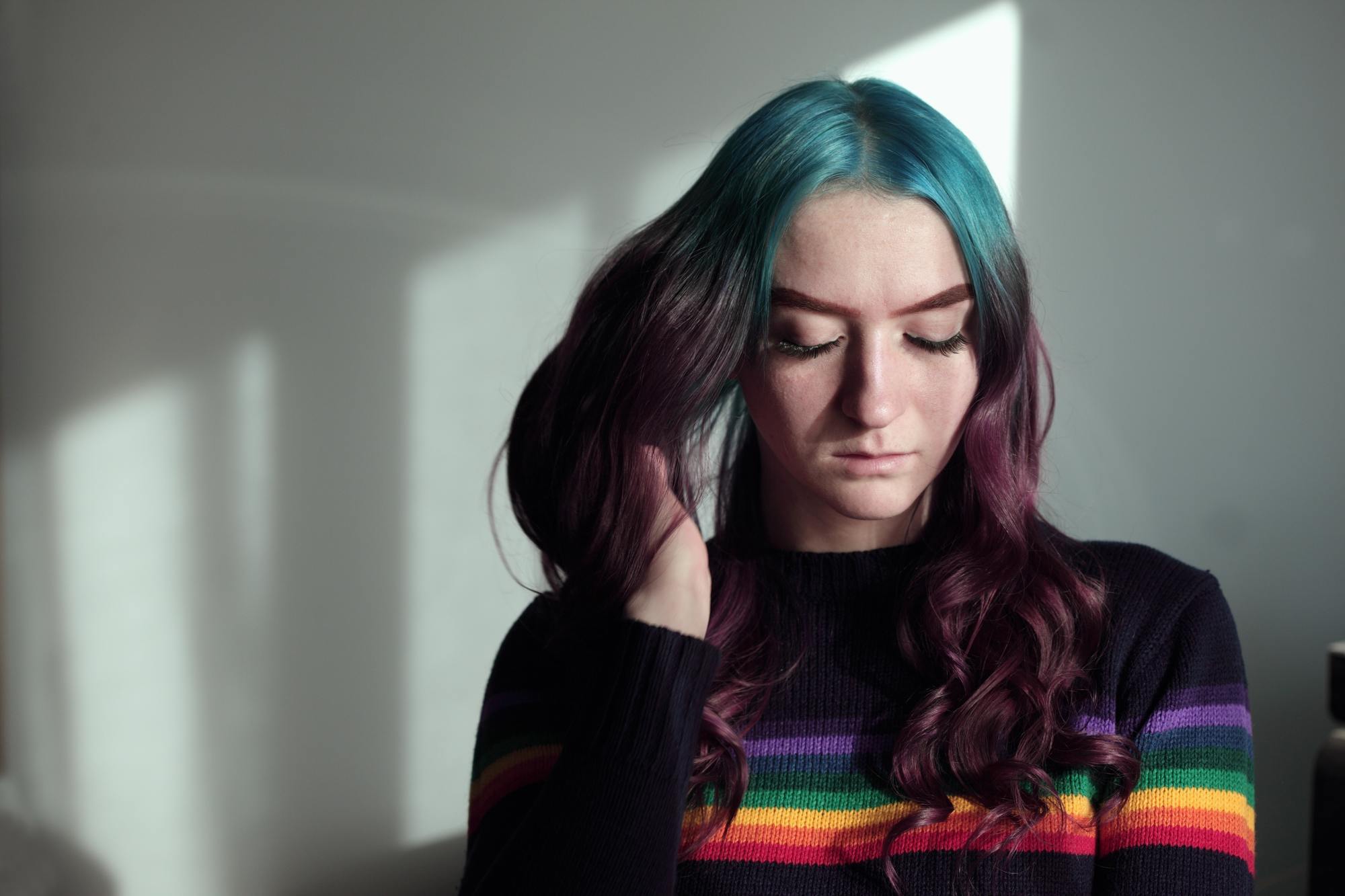 woman with turquise colour roots and purple lengths of hair