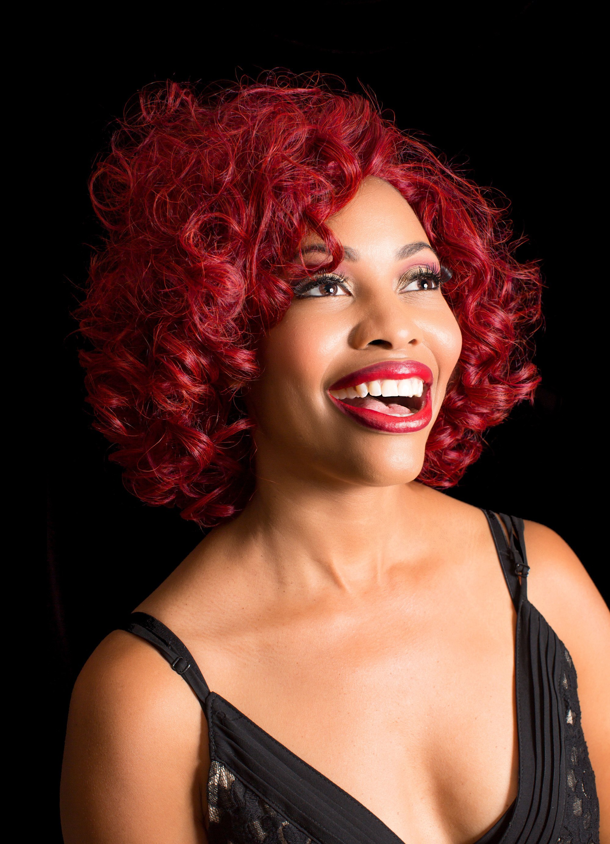 Woman with curly, vibrant red hair