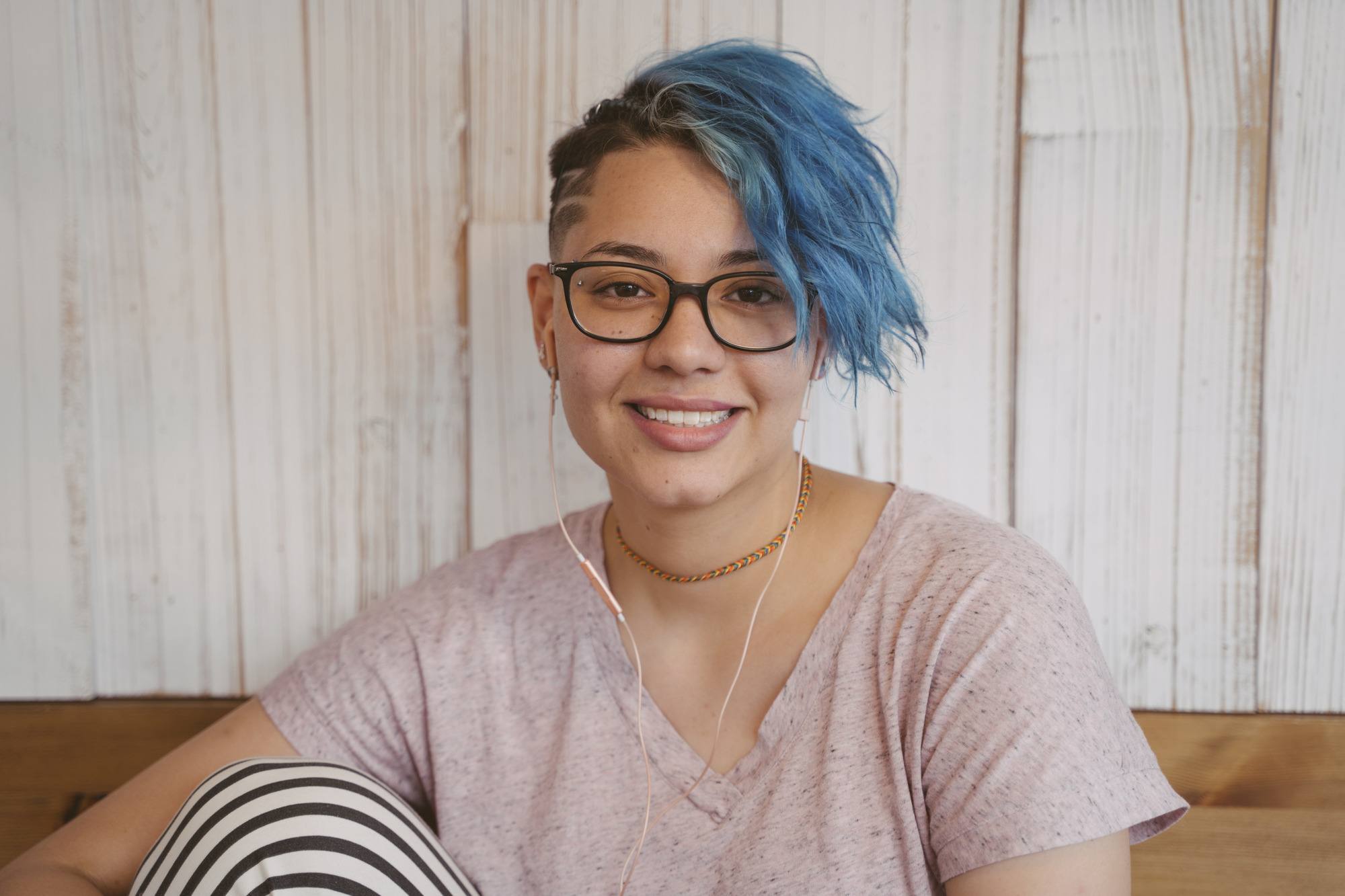 gemini hairstyles: woman with short blue hair with an undercut on the left side
