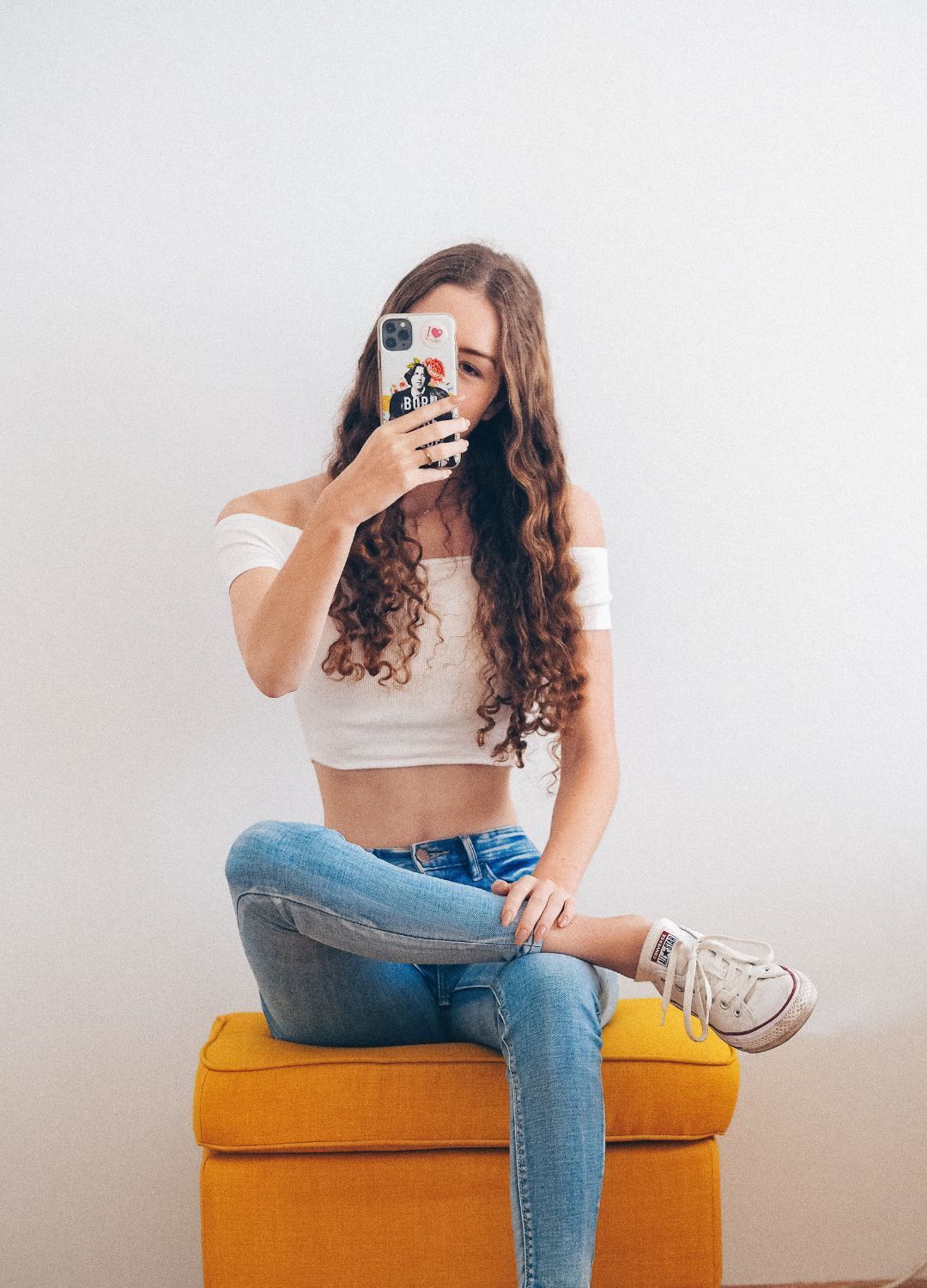 woman with very long brown hair with curly ends