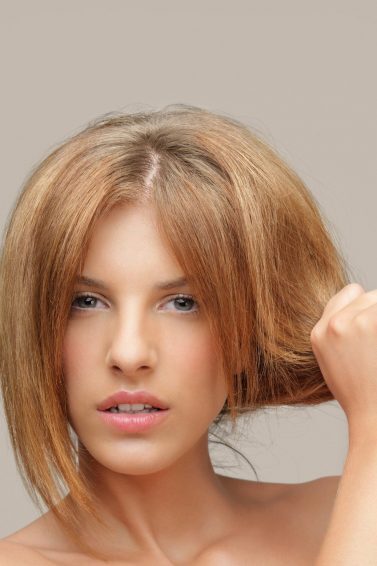 woman with long, dry light brown hair