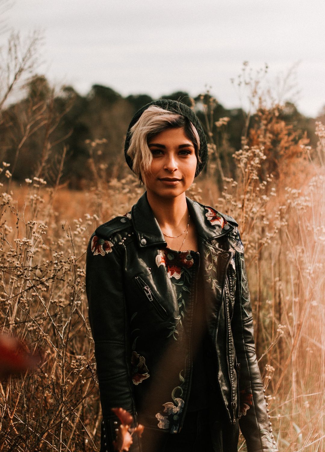 hair accessories: woman with short blonde hair, wearing a thick leather jacket and a black beanie