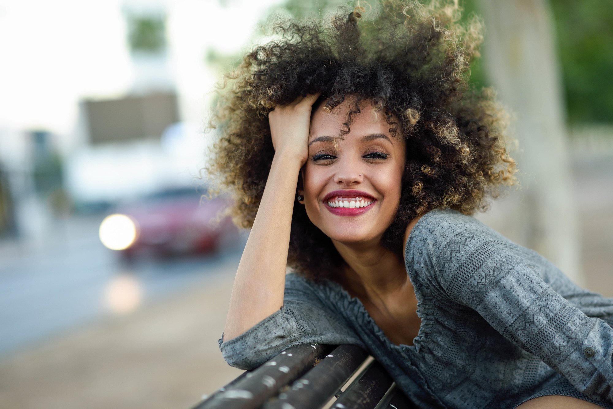 woman with bid curly afro and blonde highlights