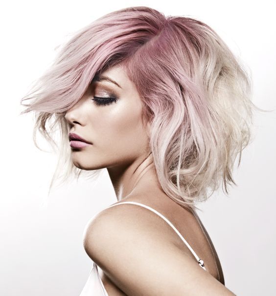 types of hair colour: Woman with wavy bob hairstyle and pink roots hair colour ashy blonde tips