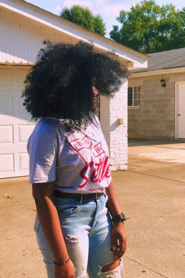 woman with stretched-out, long, thick, voluminous natural 4C hair