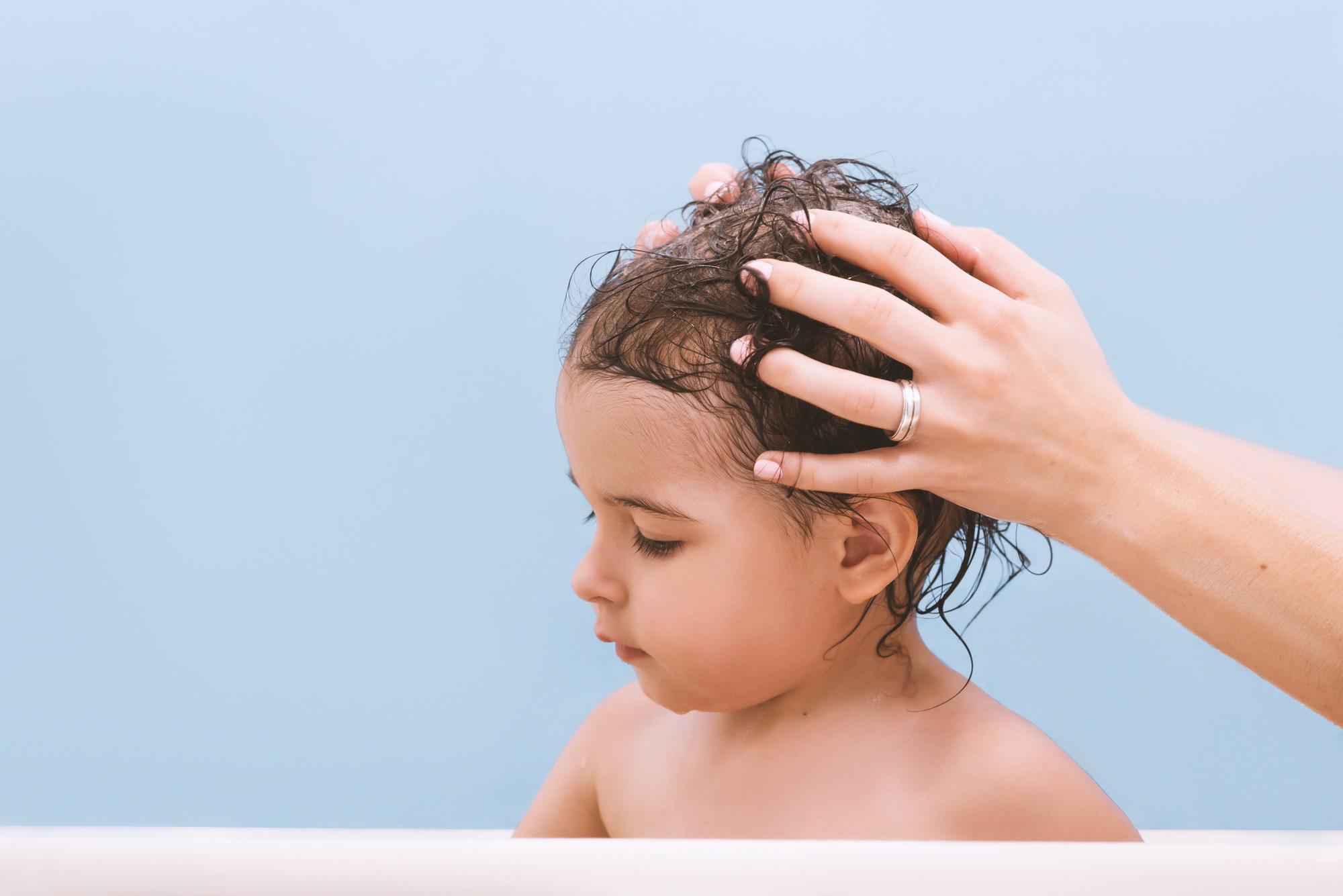 chil's hair being washed by parent