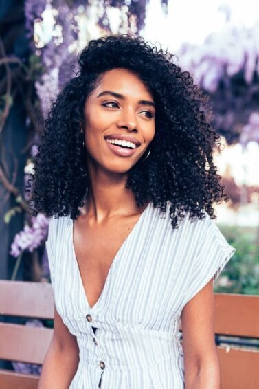 low porosity hair: woman with long dark curly hair