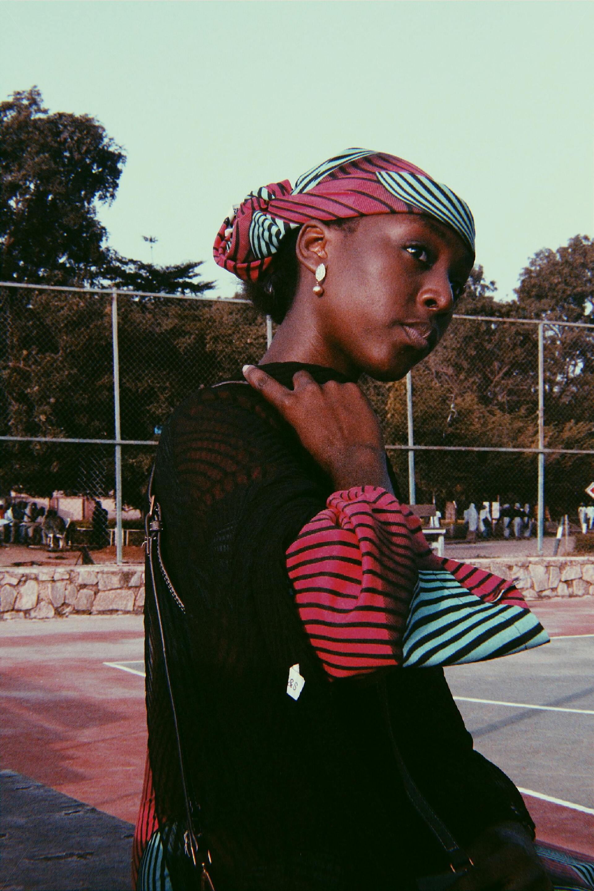 Woman wearing a red and green striped head scarf