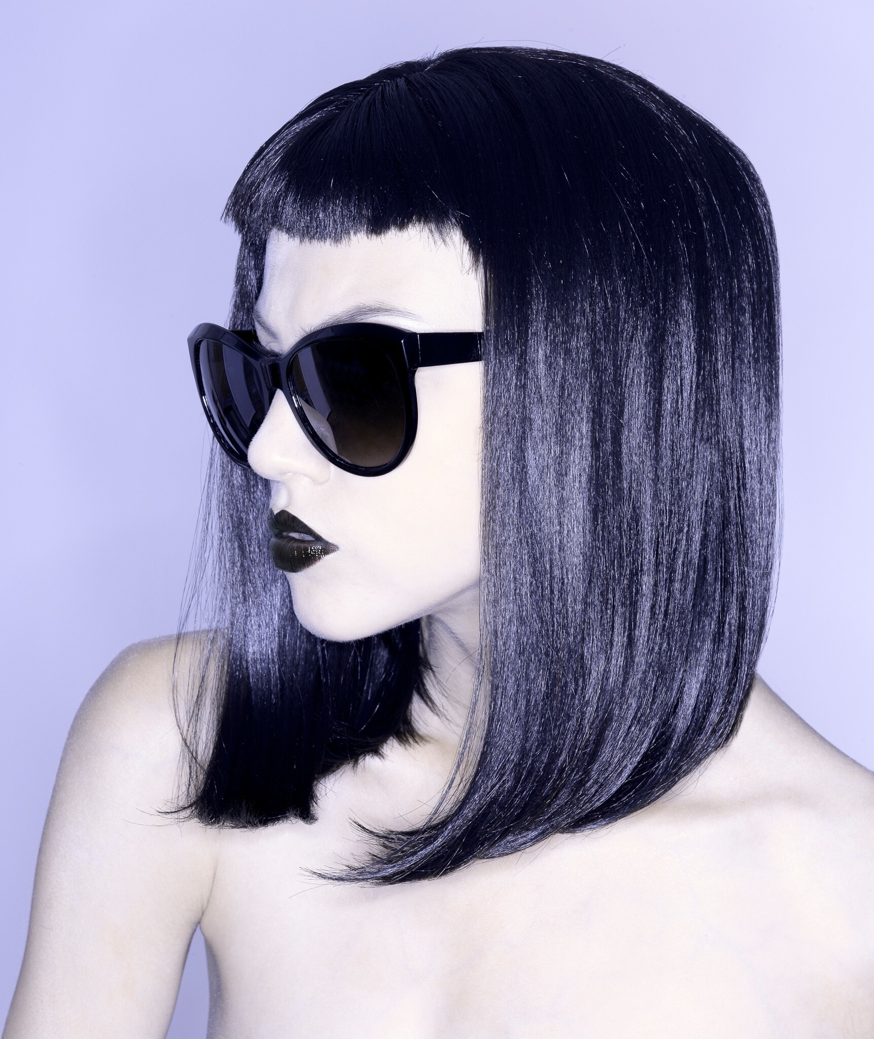 woman with pale skin dark sunglasses sleek lob bob short fringe black hair goth hairstyles