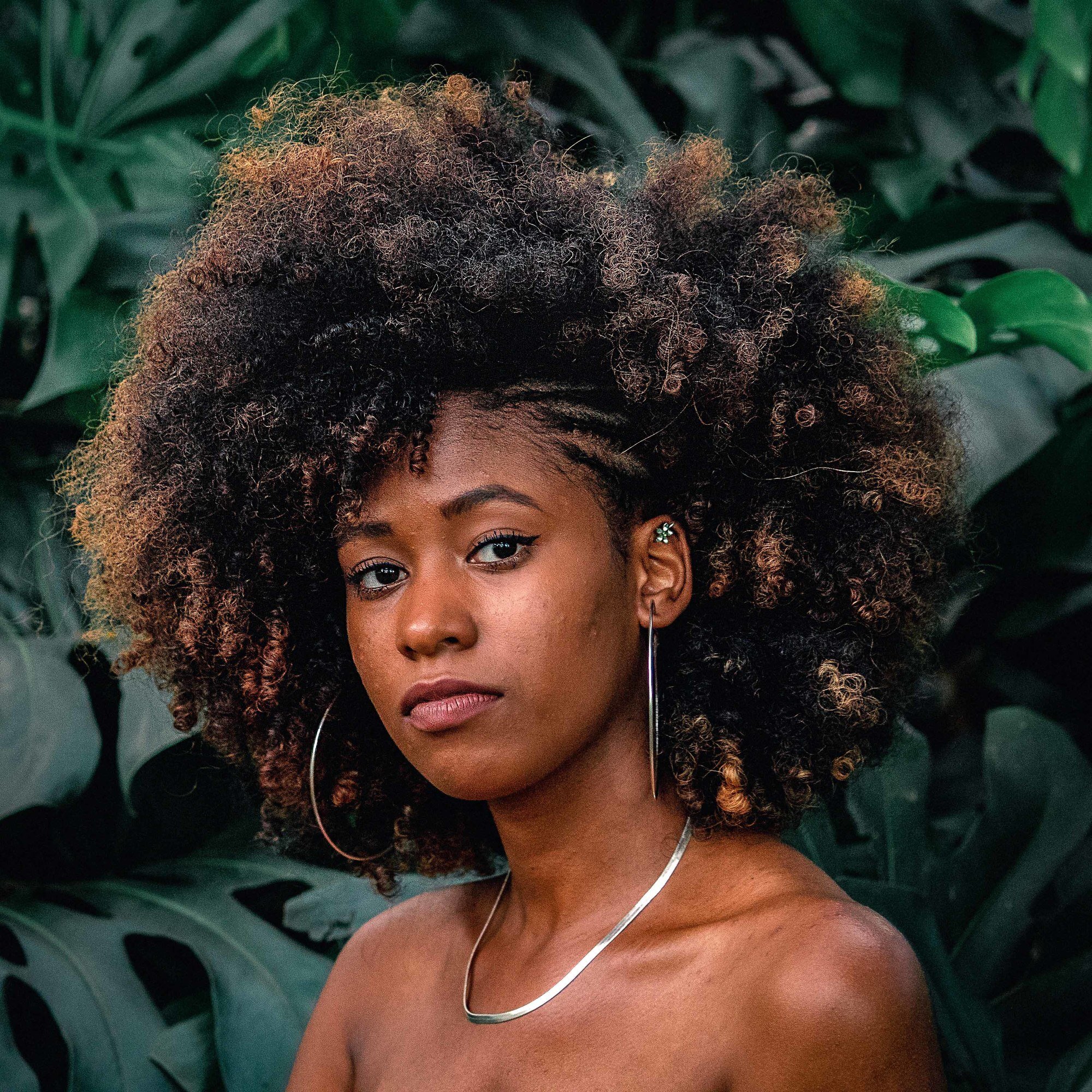 woman with dark afro hair and a few blonde highlights