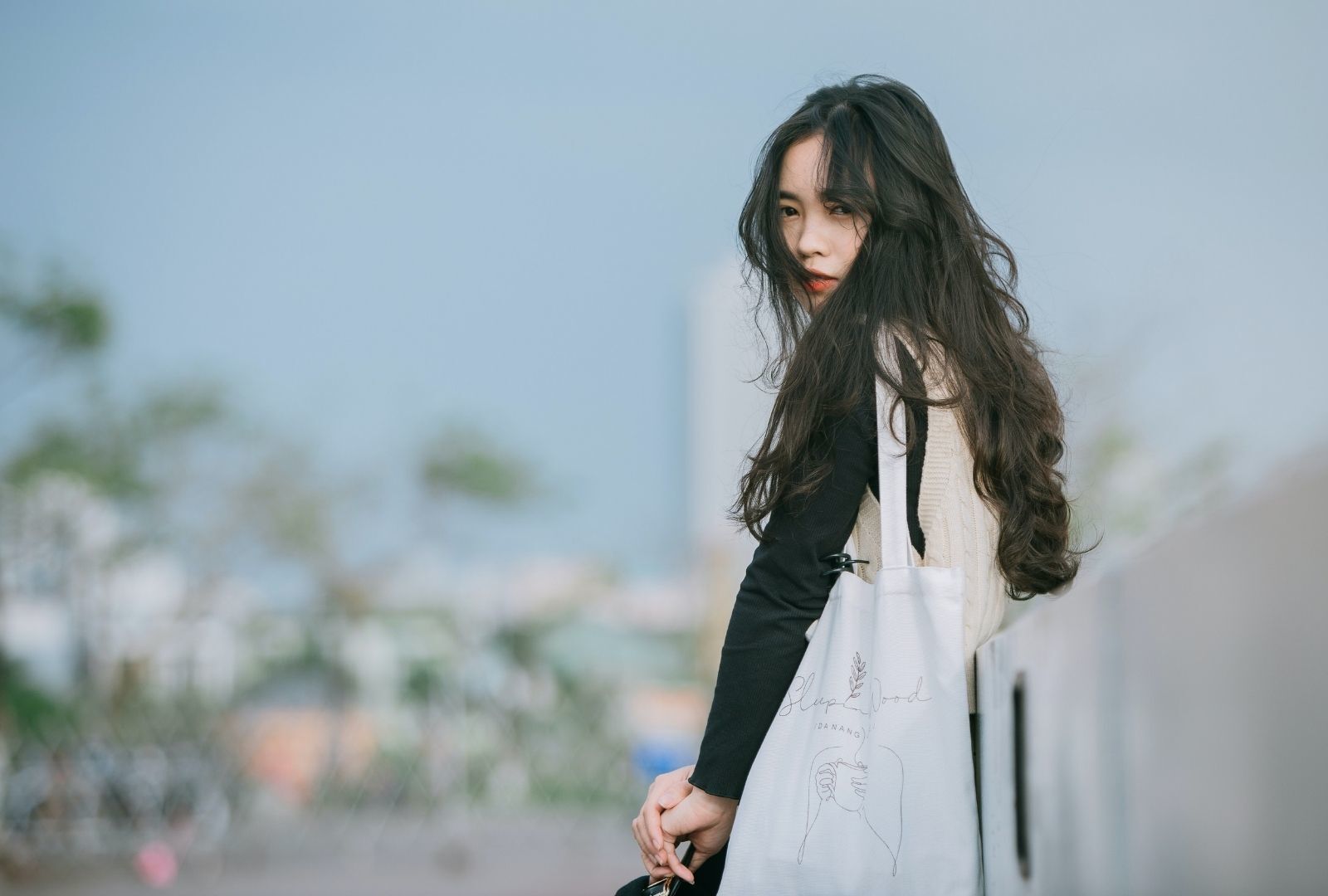 TikTok hairstyles: woman with long wavy hair cut in layers