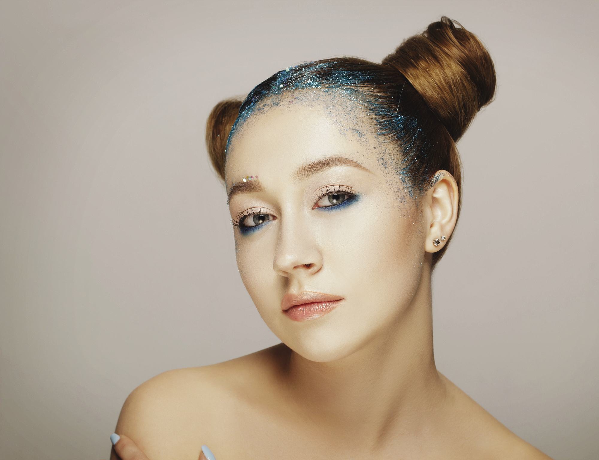 girl with space buns and blue glitter
