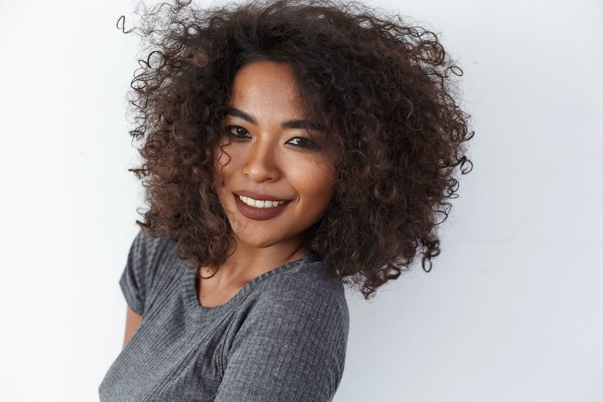 espresso hair colour: woman with voluminous naturally curly hair