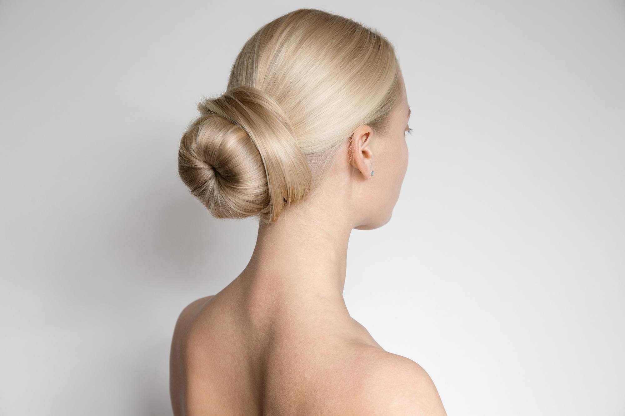woman with sleek low bun blonde hair