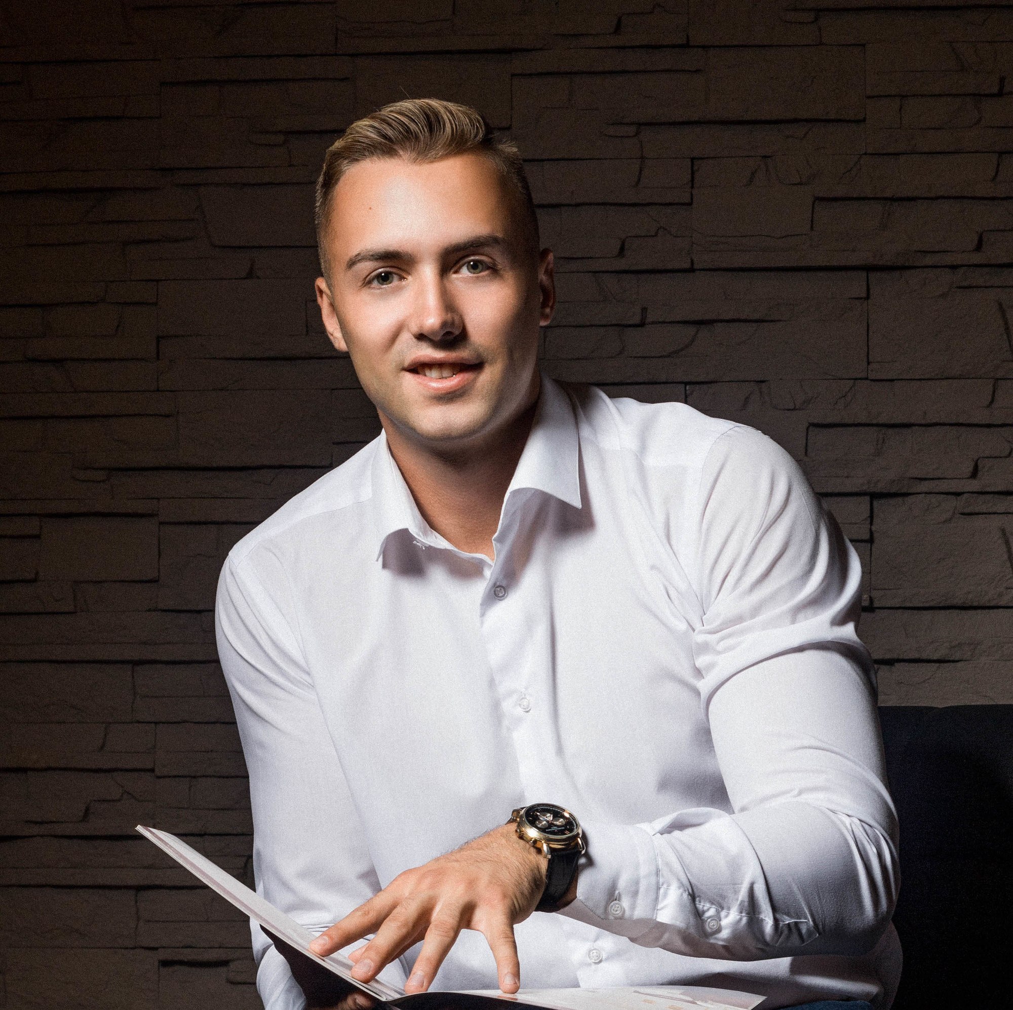 man with round face side part hairstyle and swept back quiff