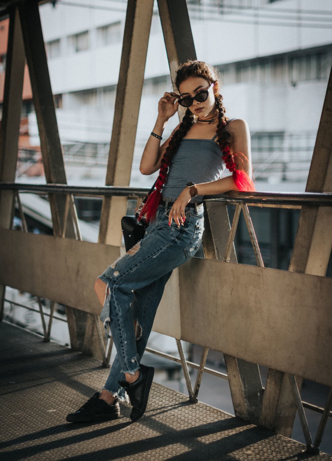 woman with long black and red hair tied into two long braids